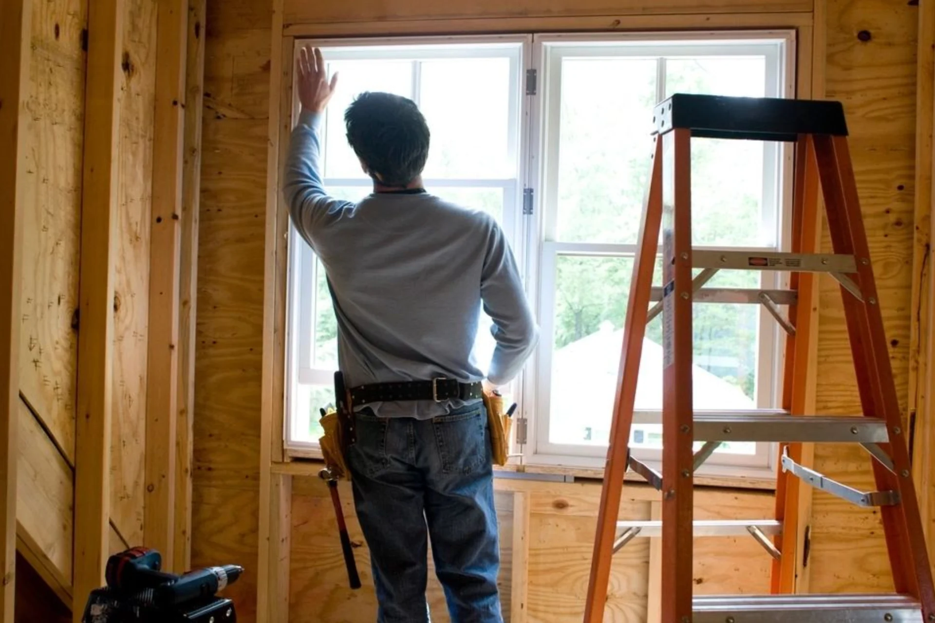 A man standing in front of a window.